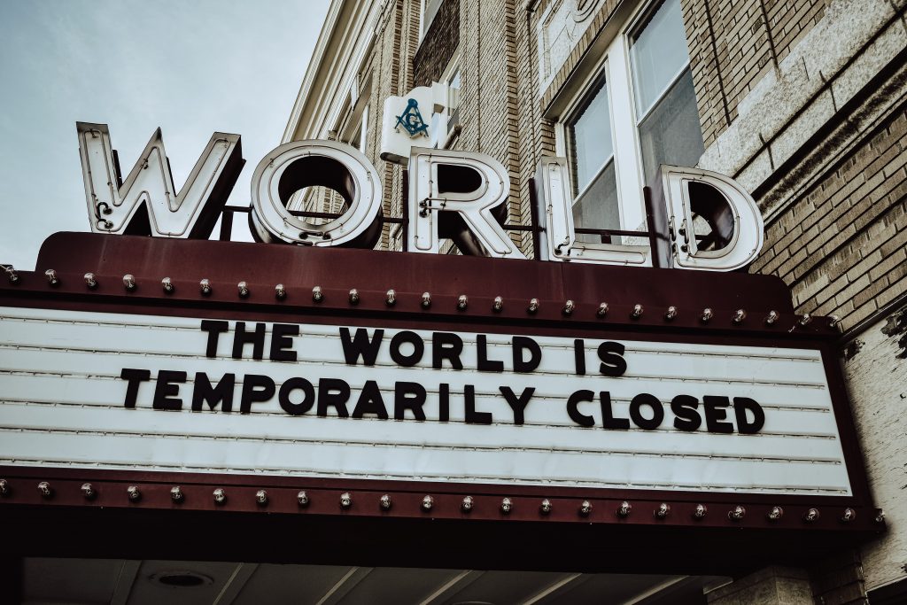 Movie theater (The World) marquee that reads, The World Is Temporarily Closed.