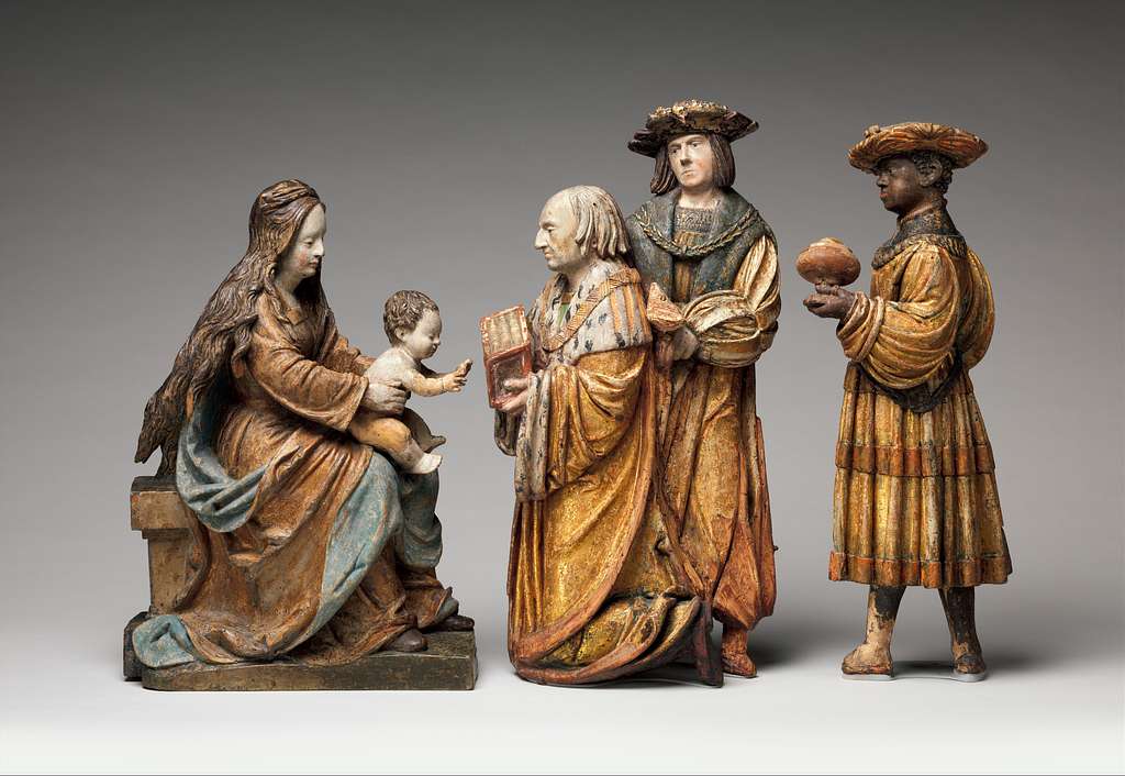 statues of magi presenting gifts to Mary and Jesus